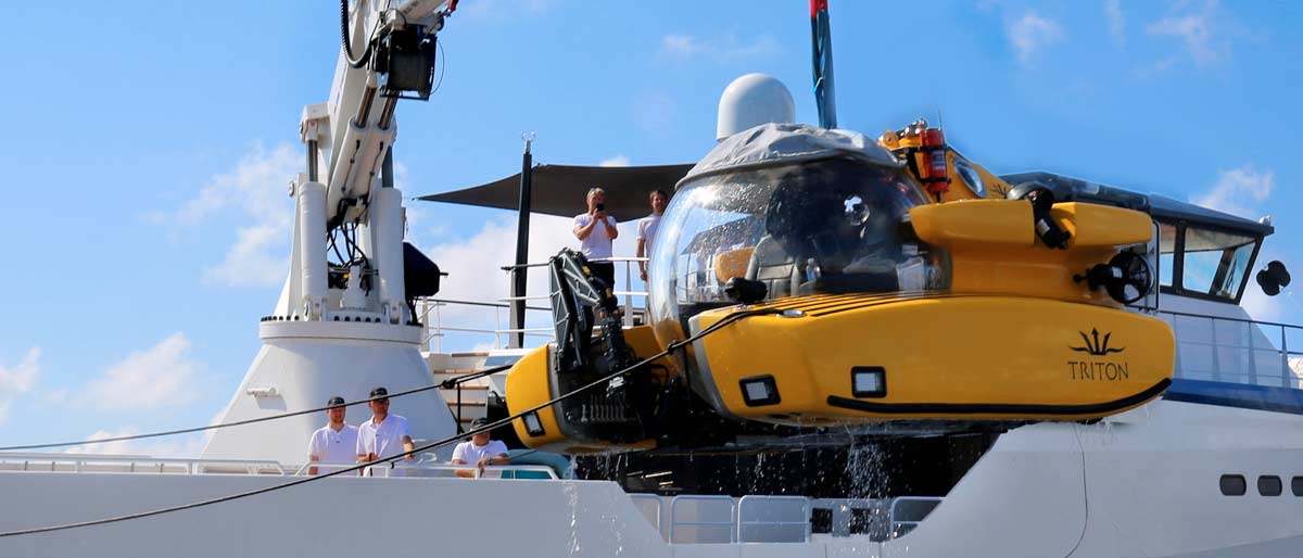 Triton submersible launching from an Expedition yacht