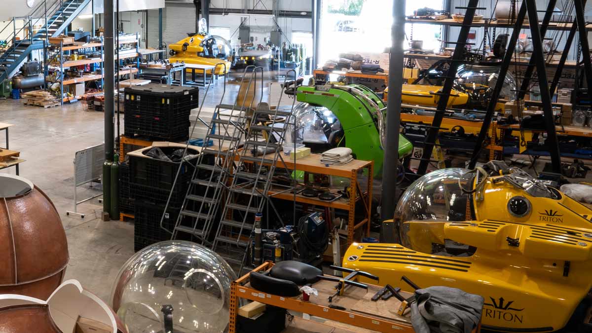 Triton’s workshop in Florida, featuring own-brand subs in build and third-party subs undergoing upgrades.